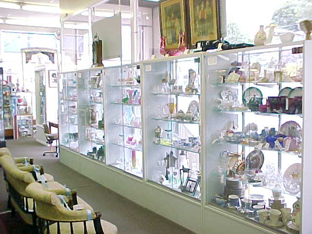 A view down a mall aisle lined with densely stocked vendor booths